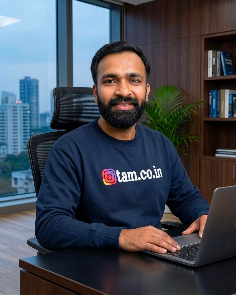 Founder of Tanabana A Manoram is wearing t-shirt with working on laptop