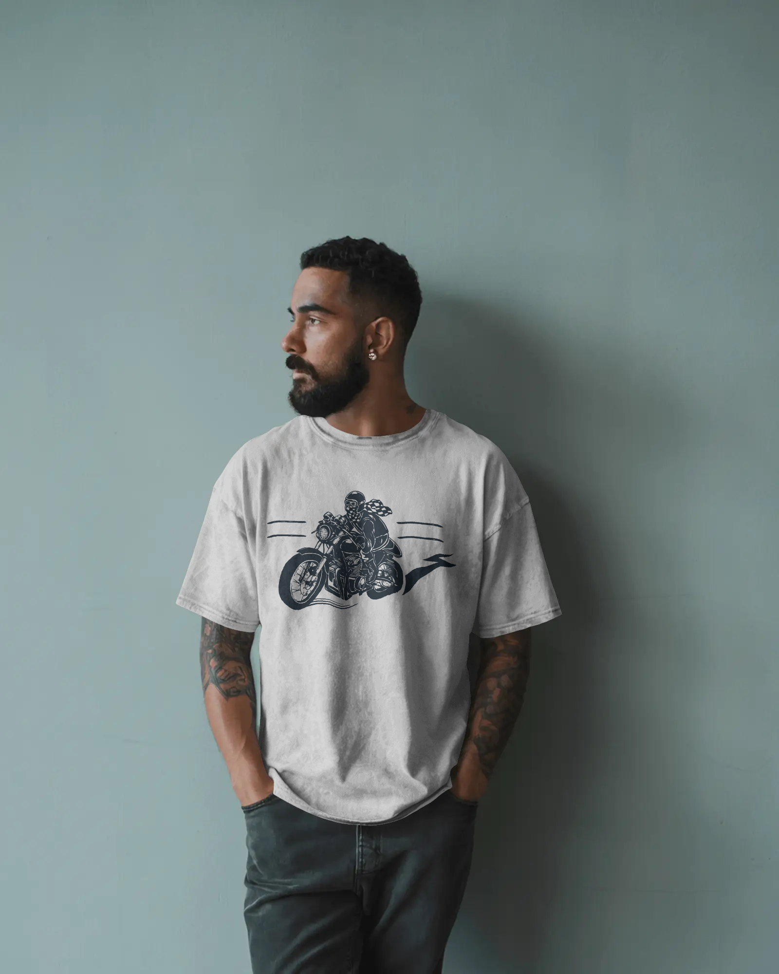Oversized white t-shirt with motorcycle graphic print worn in a relaxed streetwear style