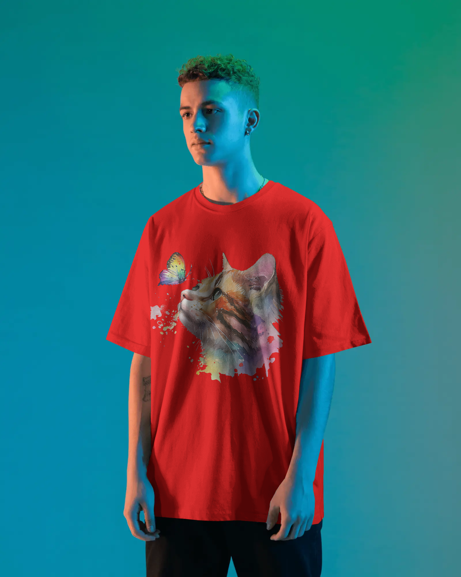 Person wearing a red t-shirt with a cat graphic on a blue gradient background