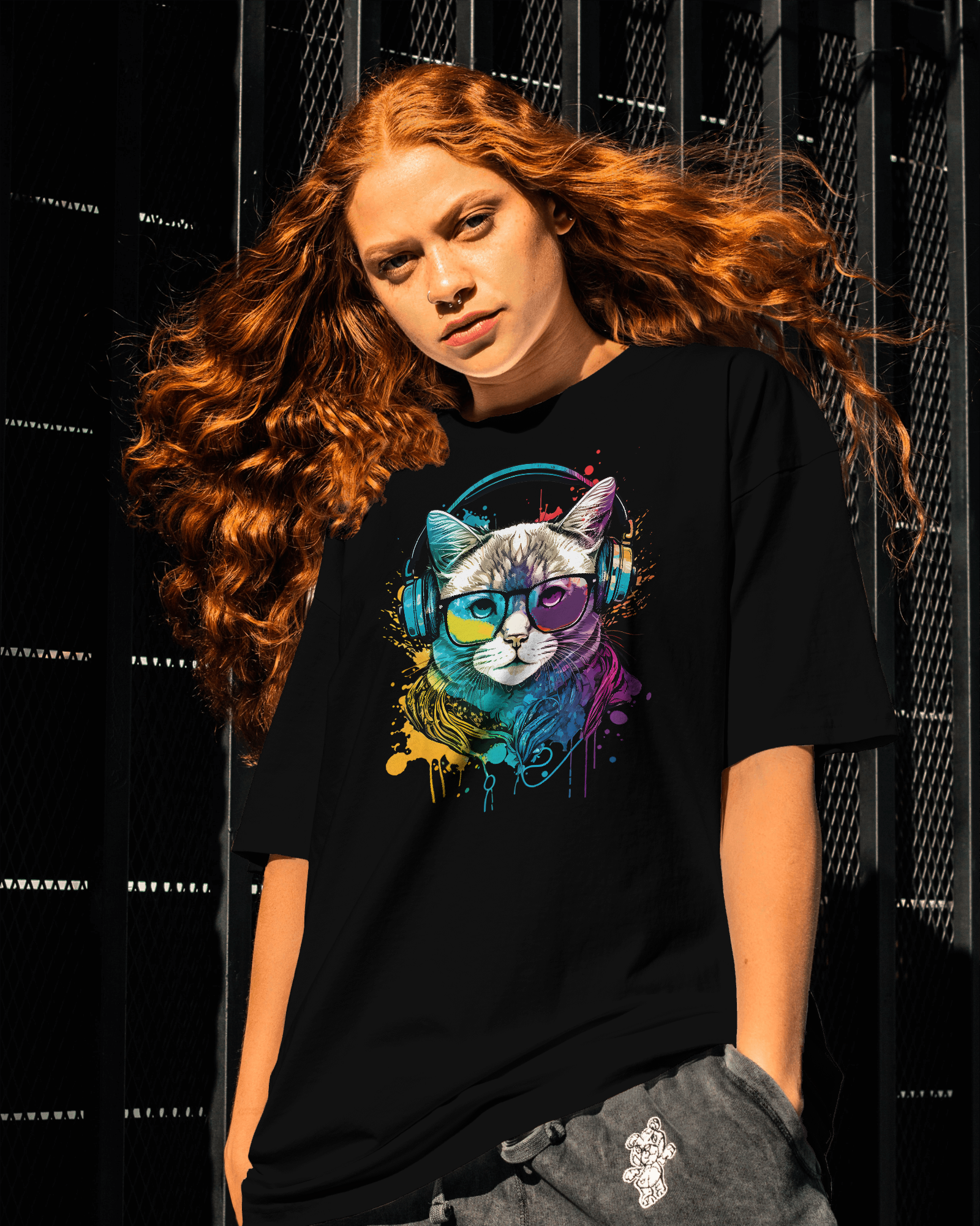 Person wearing a black t-shirt with a colorful cat graphic design.