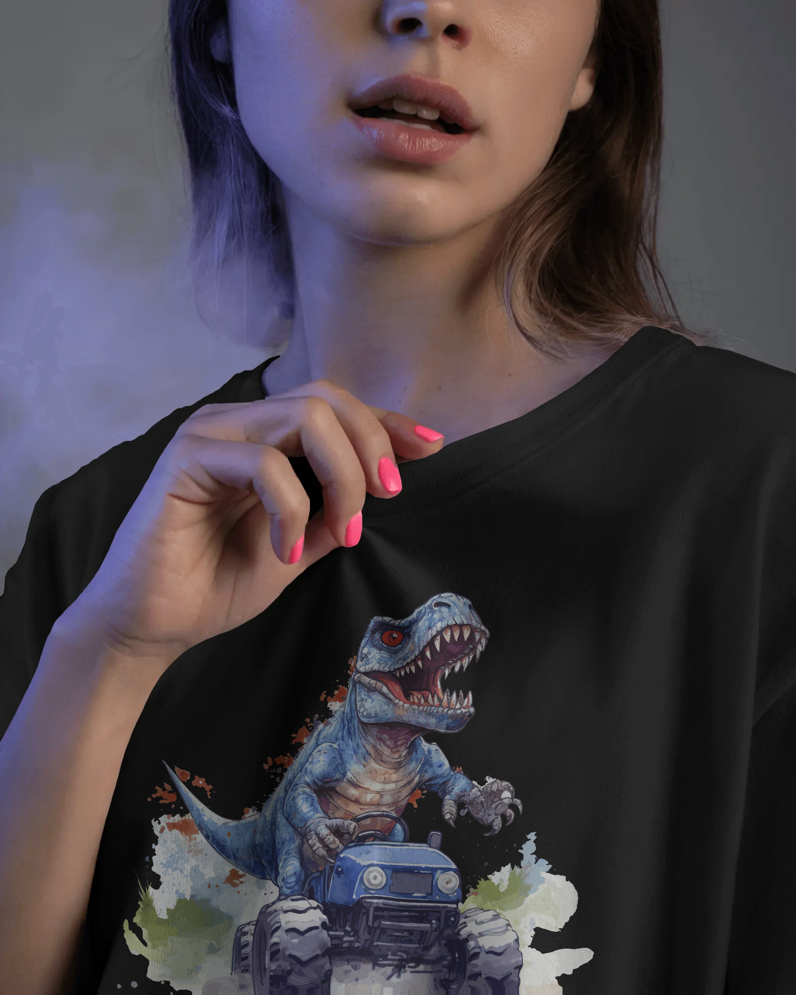 Person wearing a black t-shirt with a dinosaur graphic design.