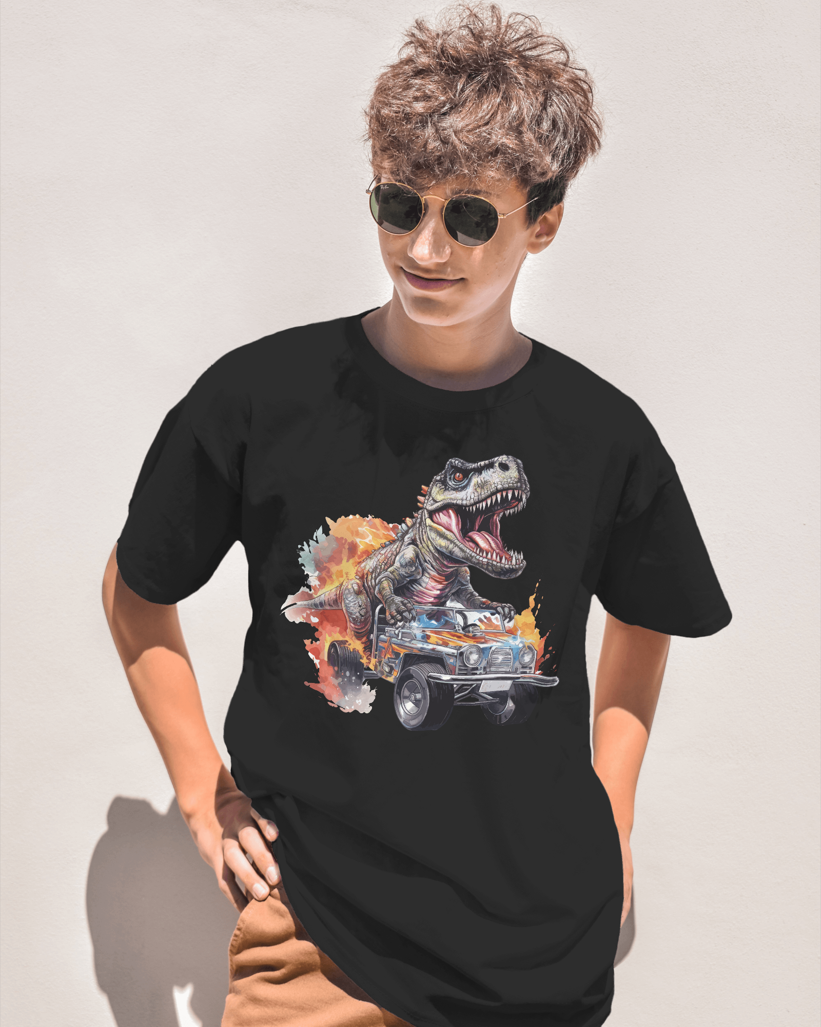 Person wearing a black t-shirt with a graphic design of a dinosaur and car on a plain background