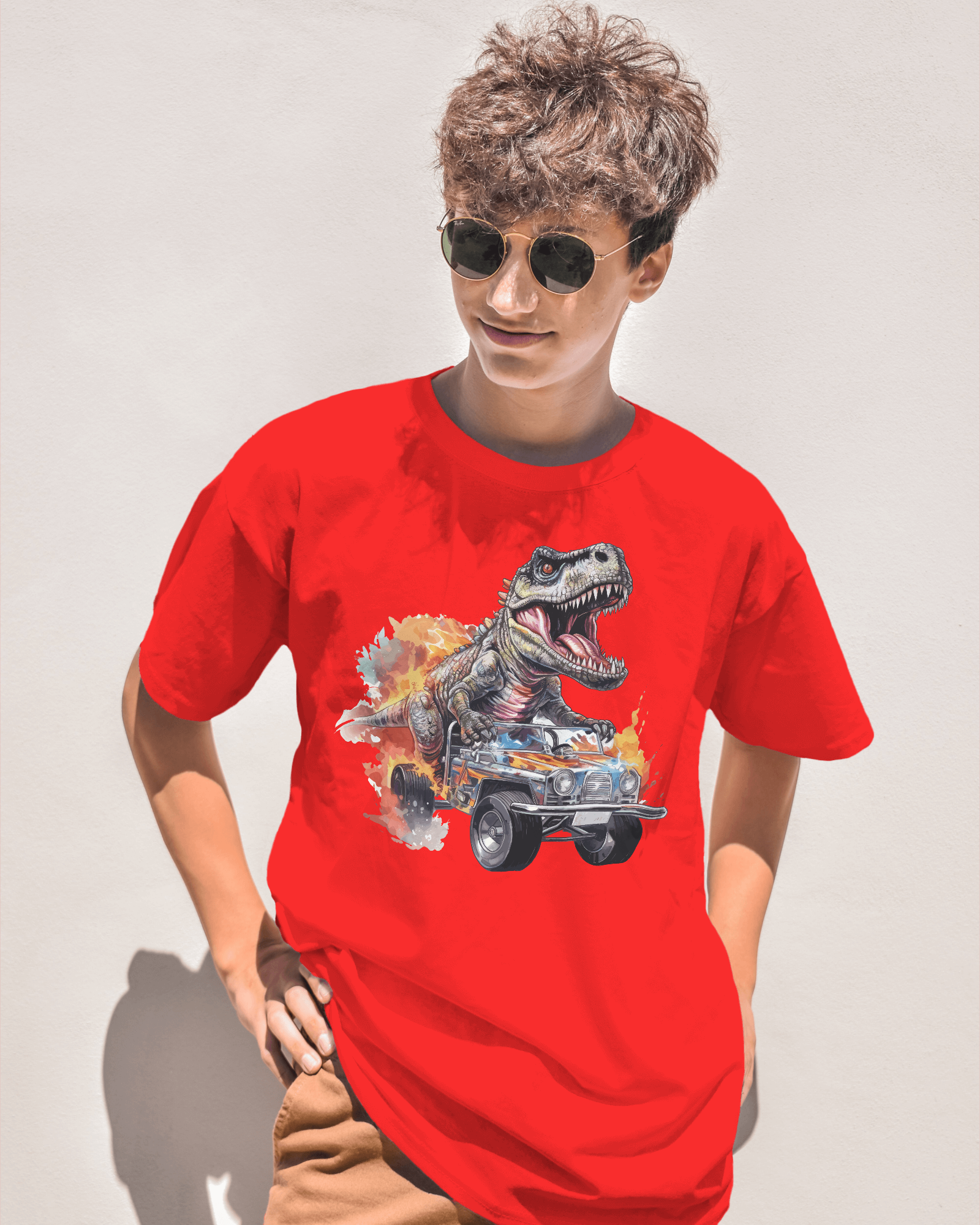 Person wearing a red t-shirt with a dinosaur graphic design on a plain background