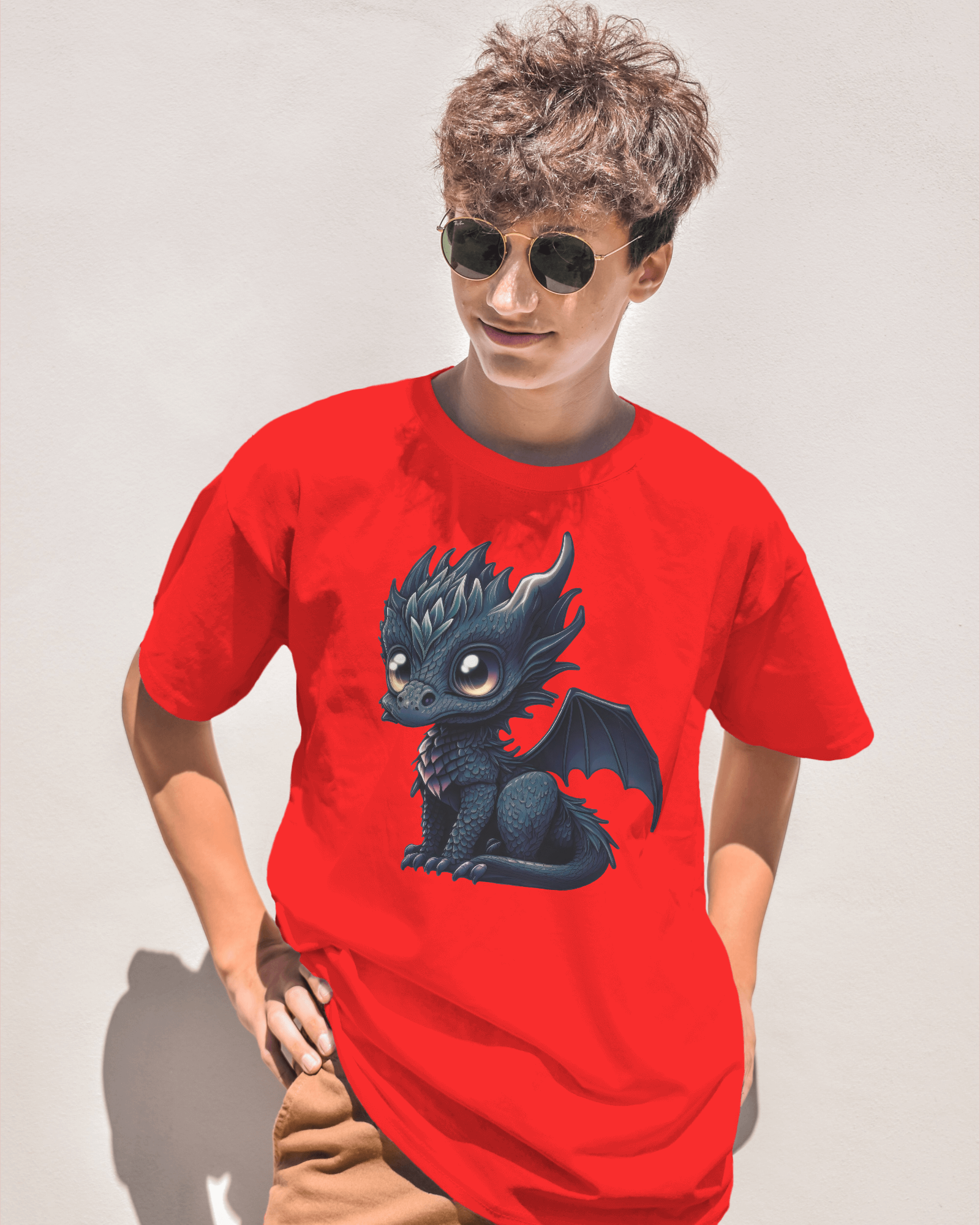 Person wearing a red t-shirt with a dragon graphic on a plain background