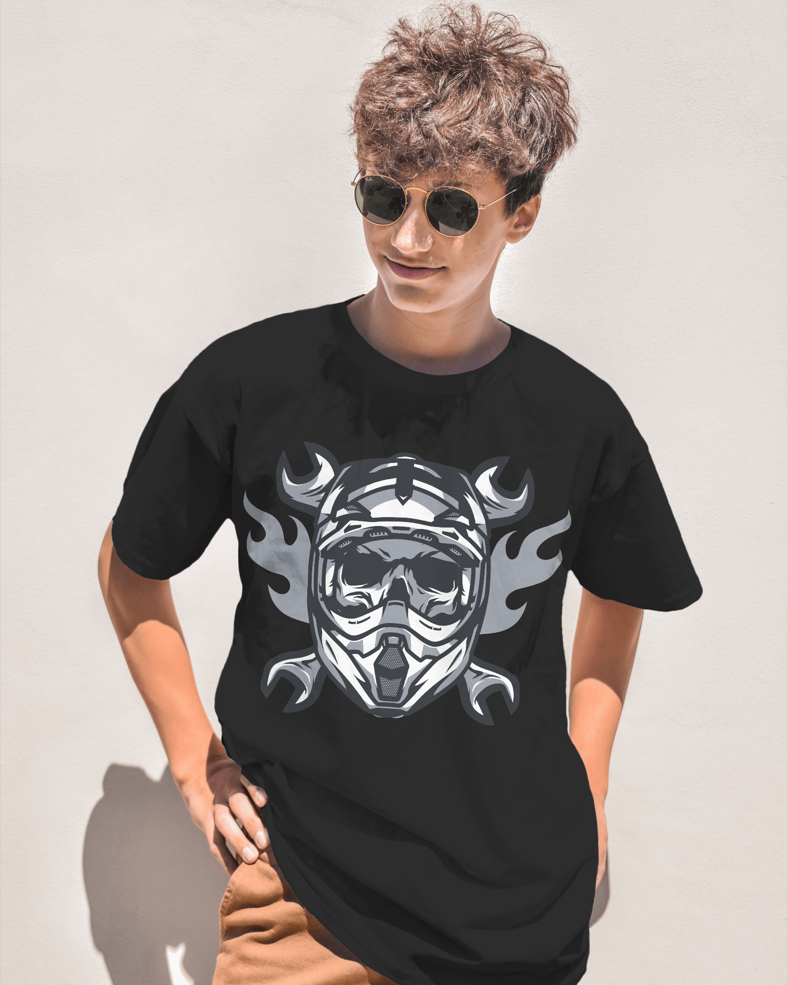 Person wearing a black t-shirt with a graphic design on a plain background