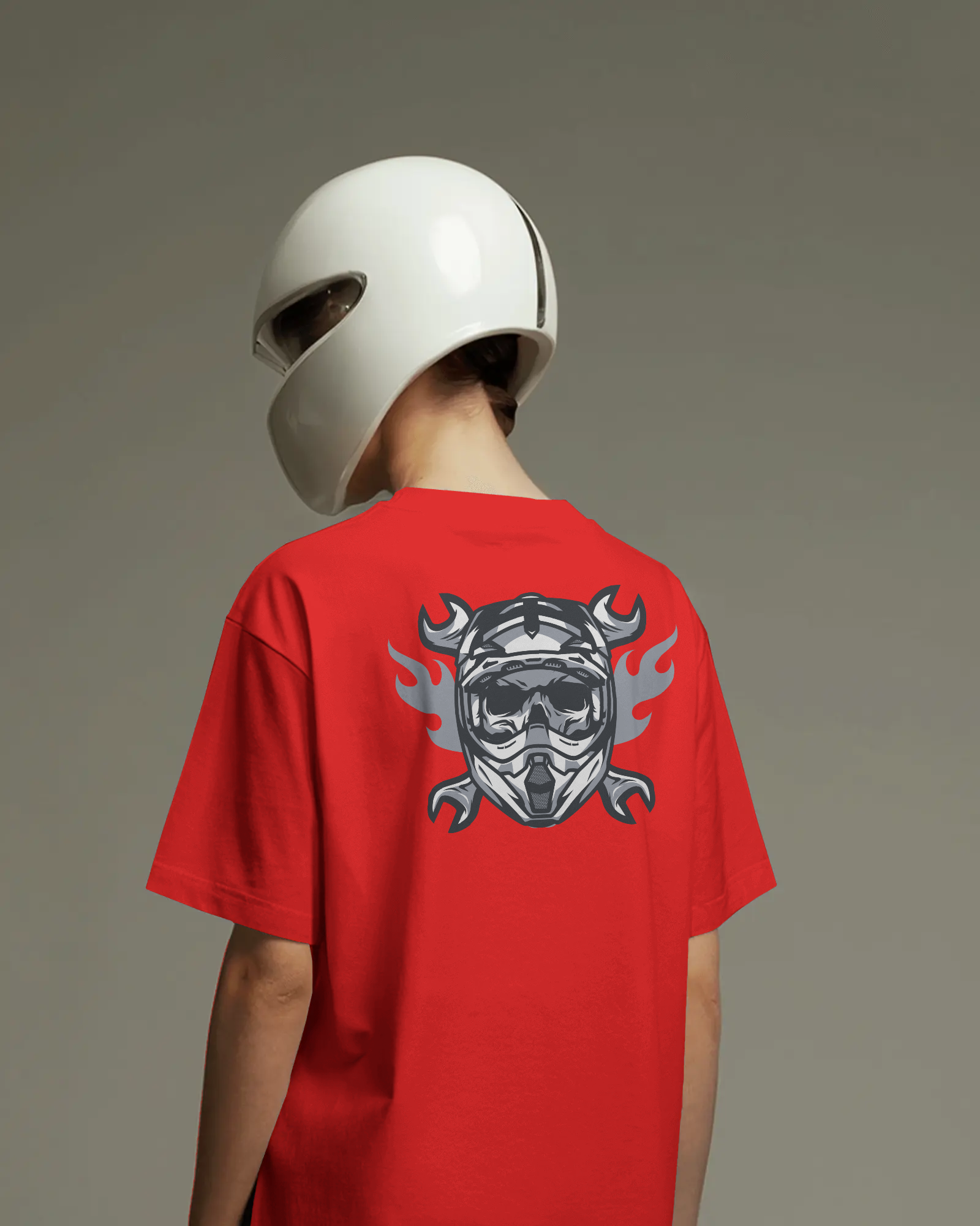 Person wearing a red t-shirt with a graphic design and a white helmet on a gray background