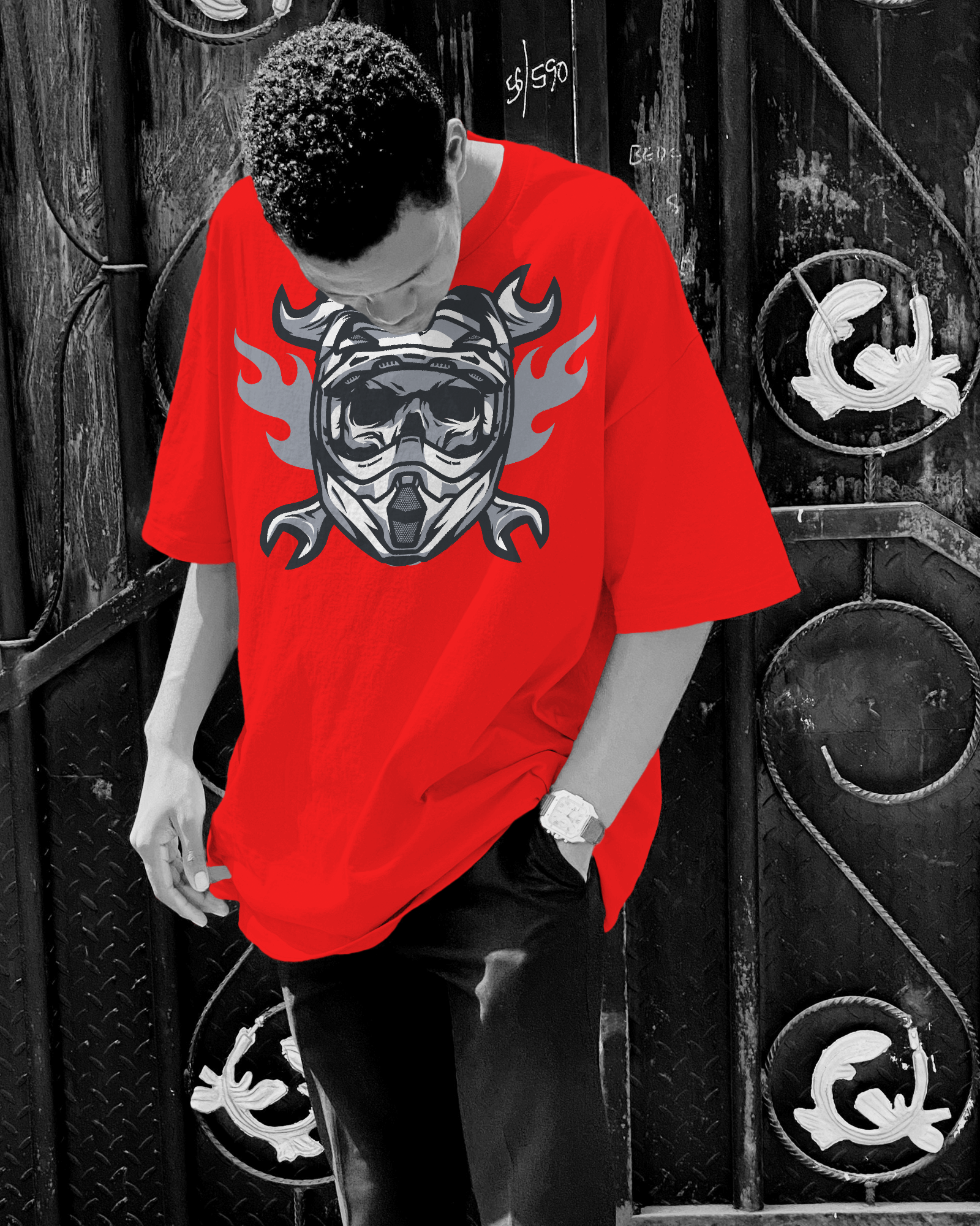 Person wearing a red t-shirt with a graphic design in front of a black and white background