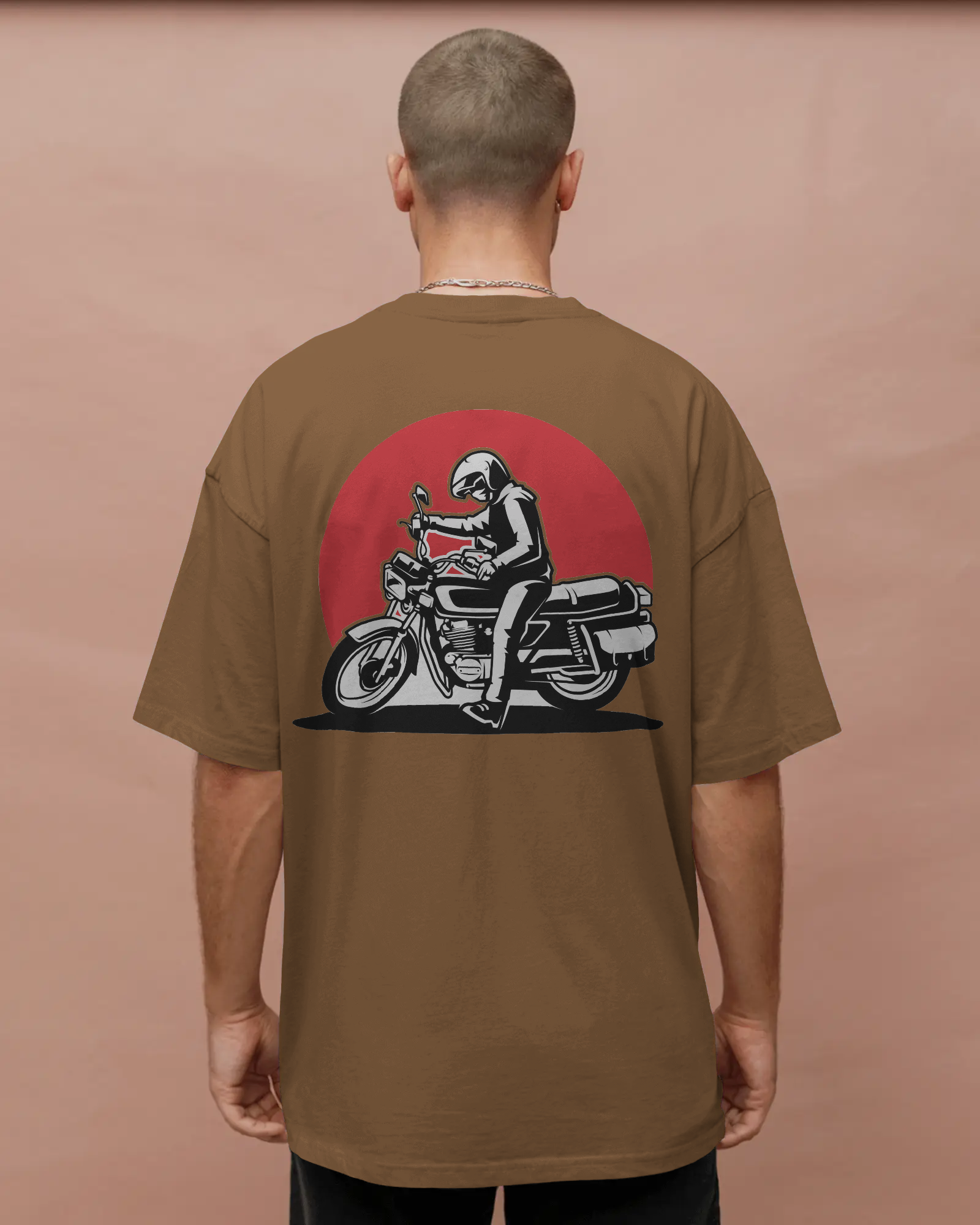 Person wearing a brown t-shirt with a graphic of a person on a motorcycle on the back against a pinkish-brown background by Tanabana A Manoram