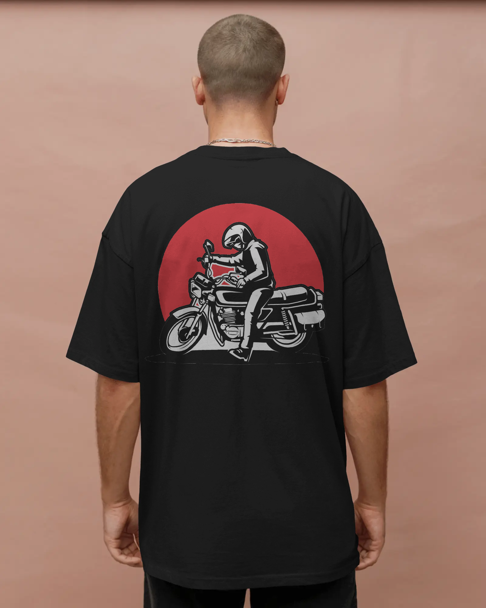 Person wearing a black t-shirt with a graphic of a person on a motorcycle on the back against a brown by Tanabana A Manoram 