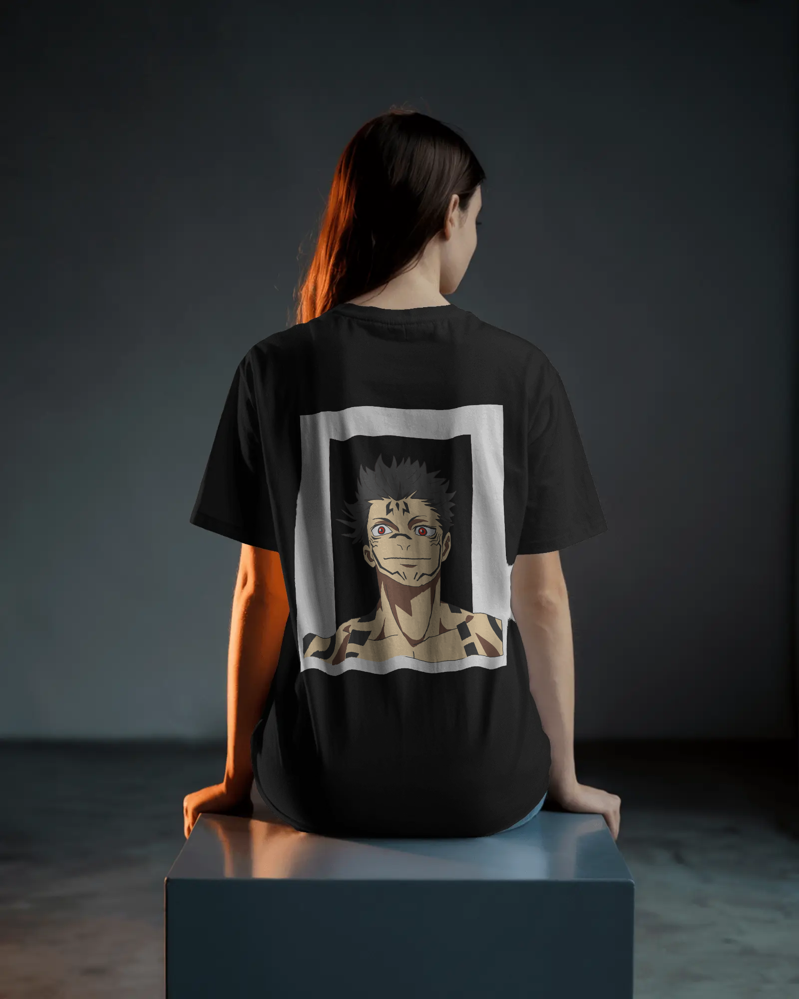 Person wearing a black t-shirt with an anime character design on the back against a dark background