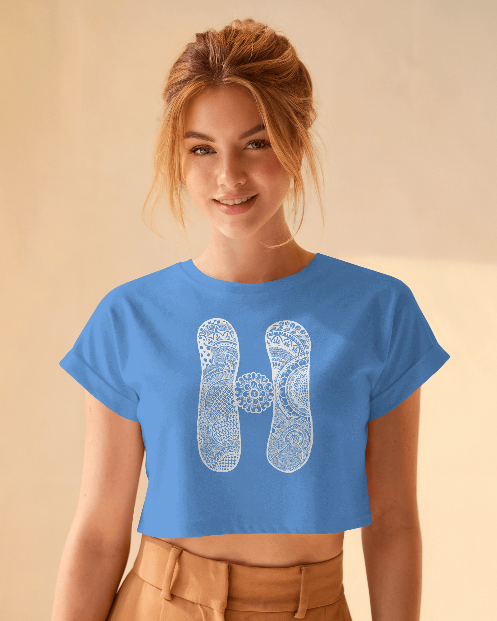 Woman wearing a blue t-shirt with a white design on a beige background