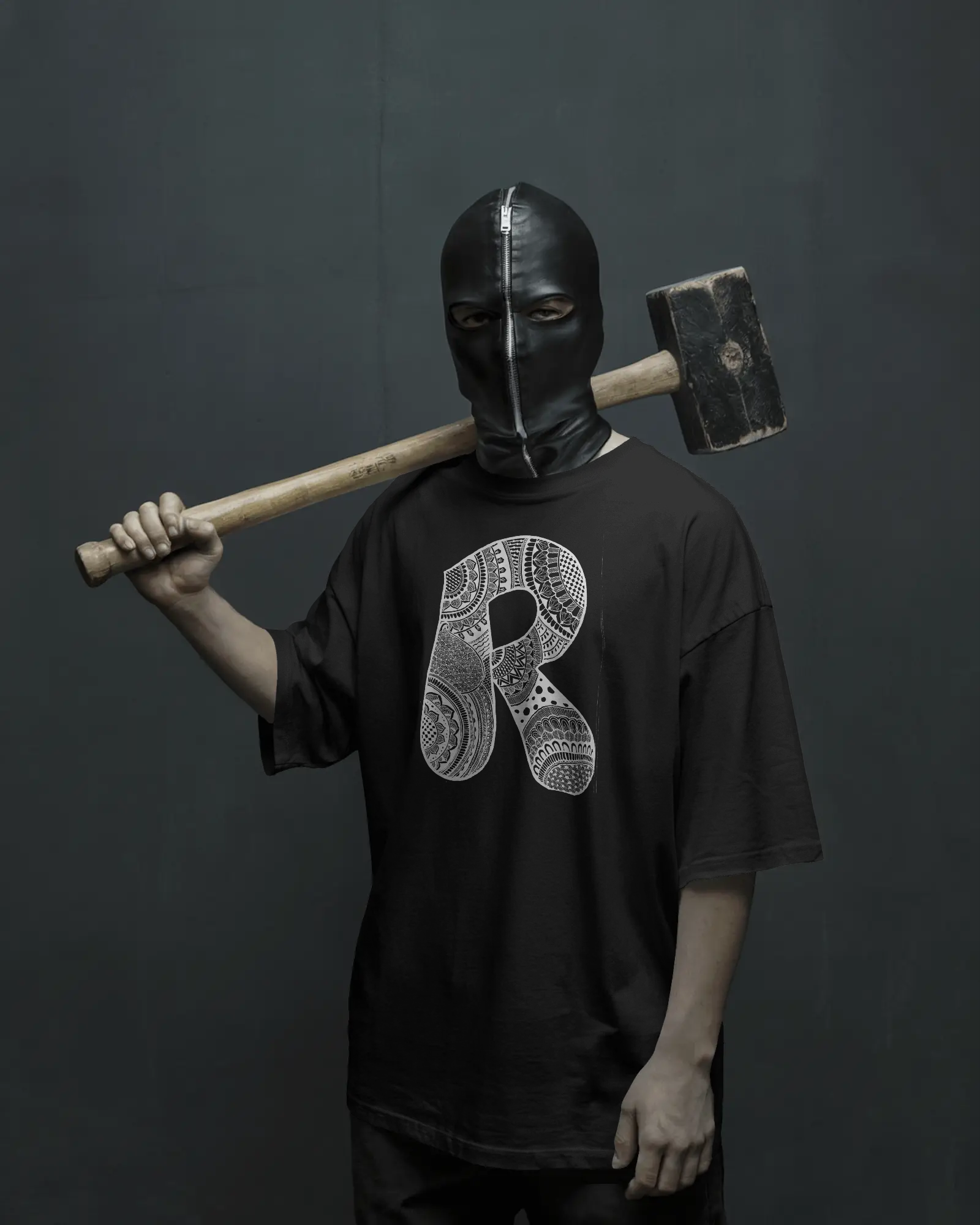 Person wearing a black mask and holding an axe against a dark background