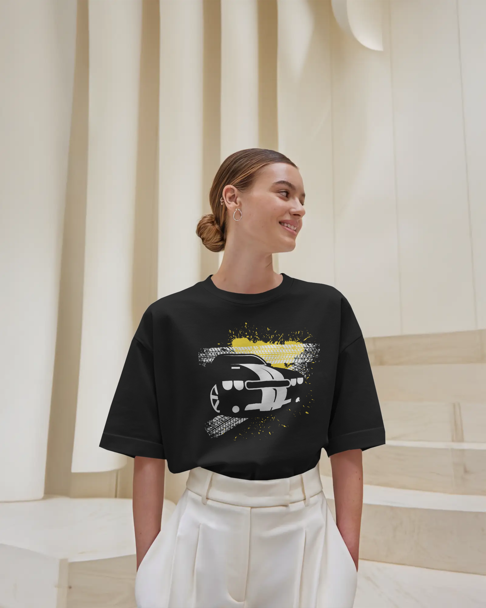 Black oversized t-shirt with car graphic front print worn in streetwear style