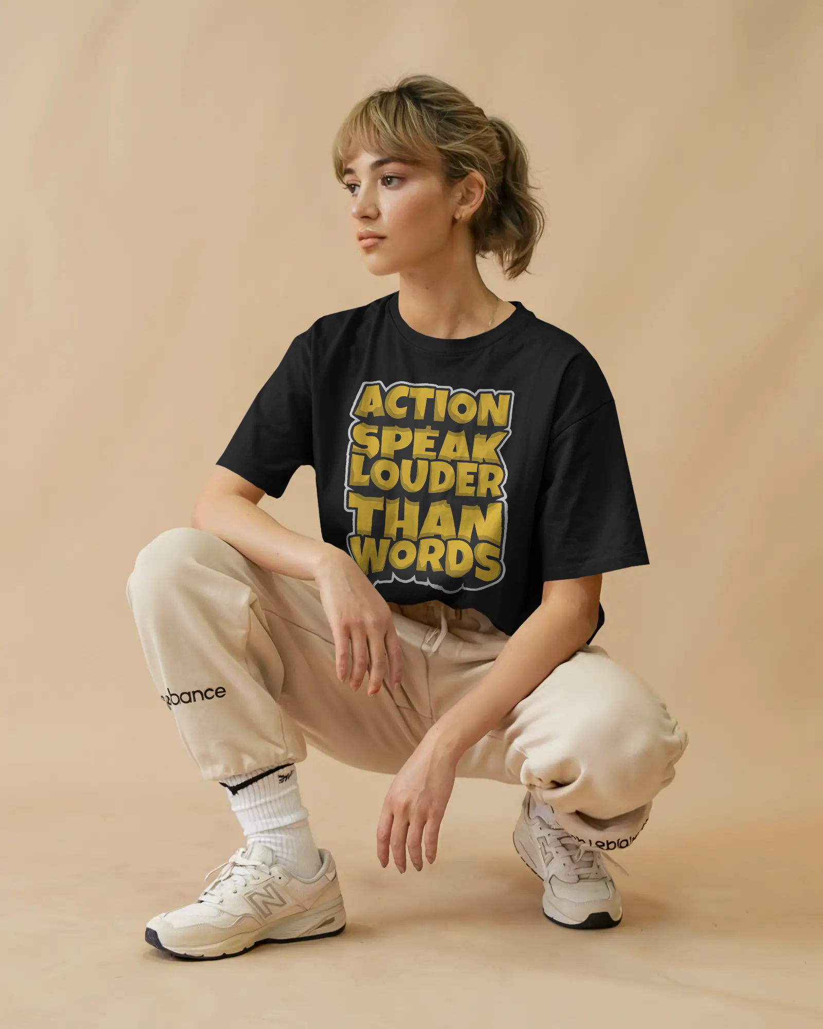 Black oversized t-shirt with quote text graphic front print worn in streetwear style