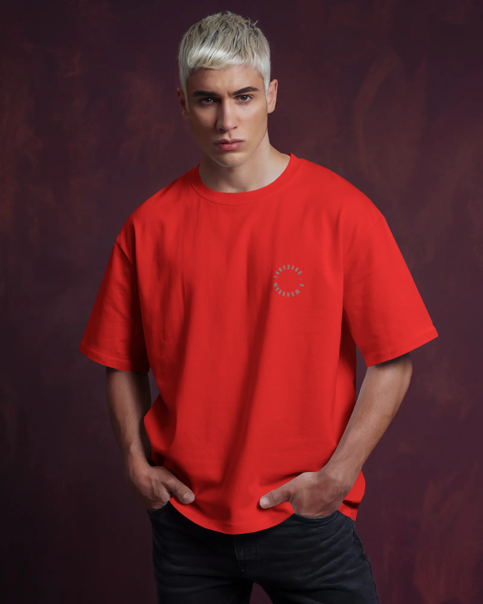 Person wearing a red t-shirt with a logo on a dark background by Tanabana A Manoram