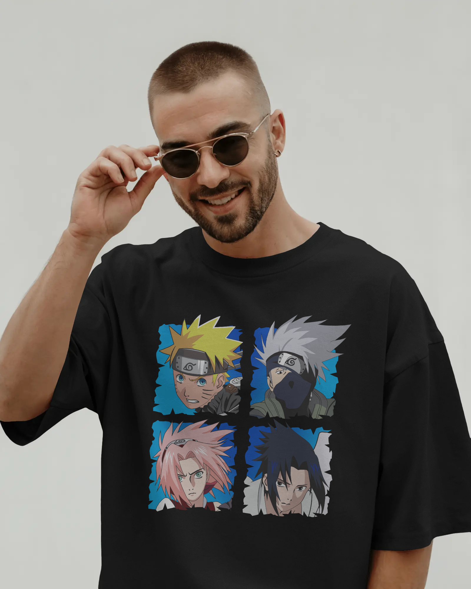 Black oversized t-shirt with a colorful Naruto team 7 design on front by Tanabana A Manoram