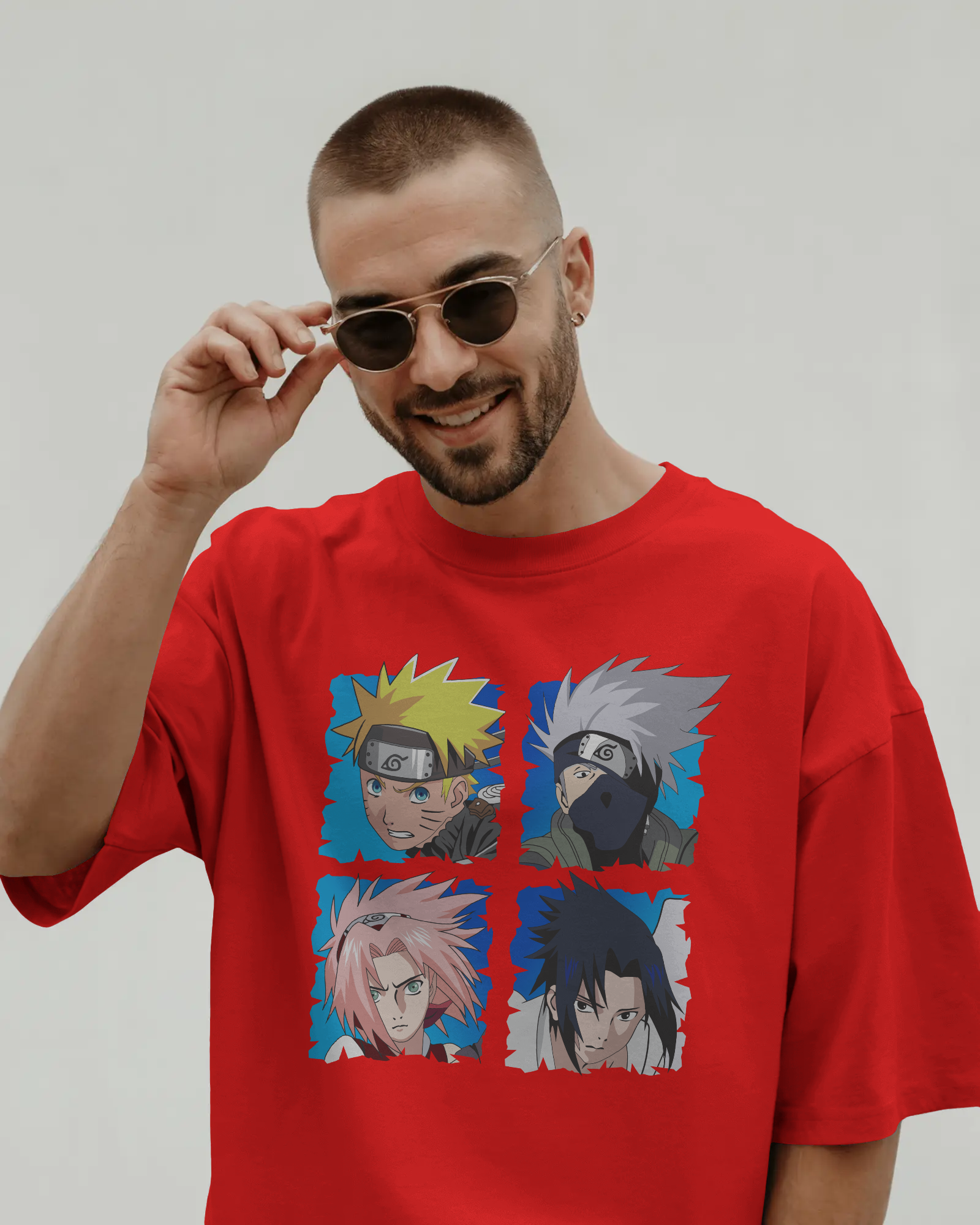 Red oversized t-shirt with a colorful Naruto team 7 design on front by Tanabana A Manoram