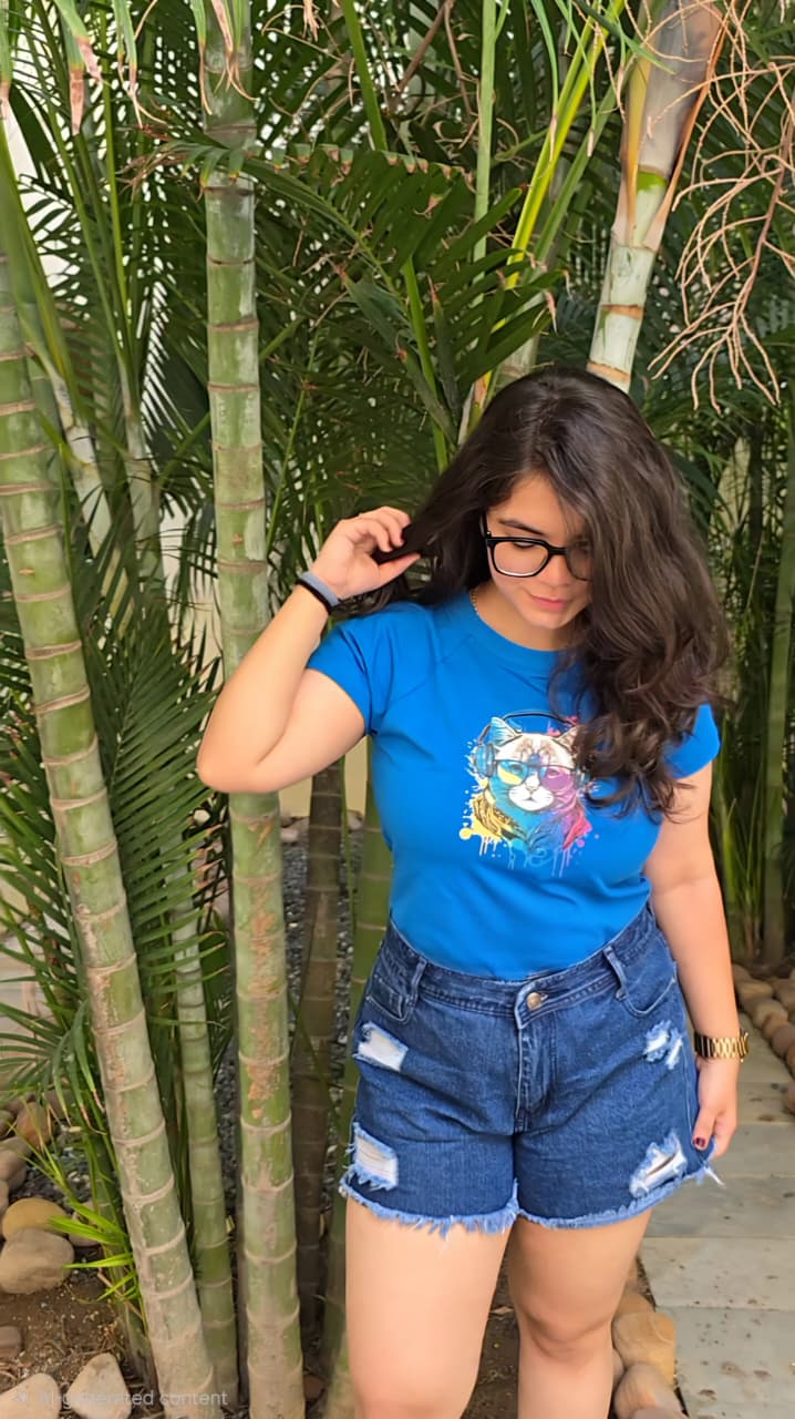 Blue crop top with colorful cat wearing headphones and sunglasses graphic print, front view