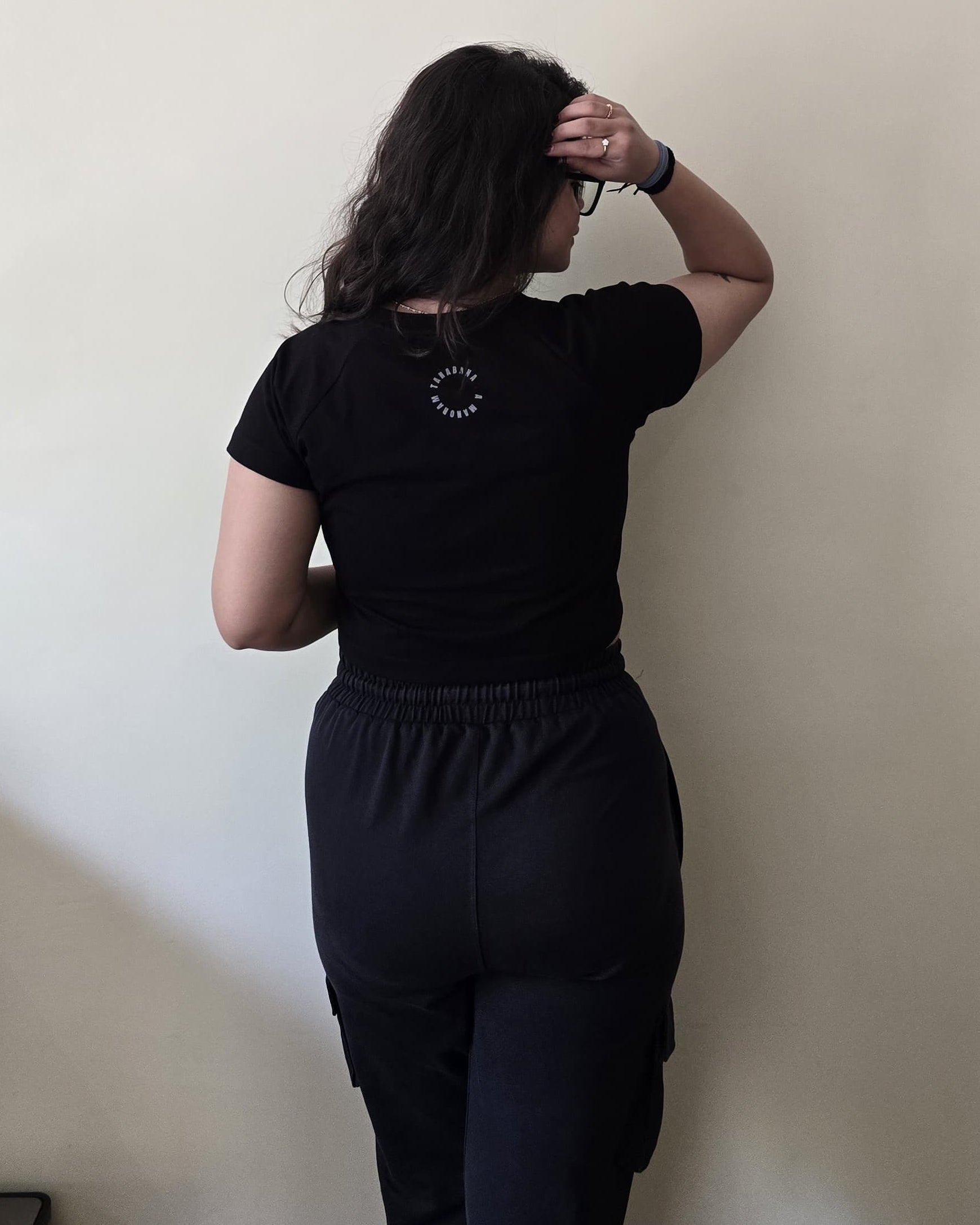 Black crop top with graphic print, back view
