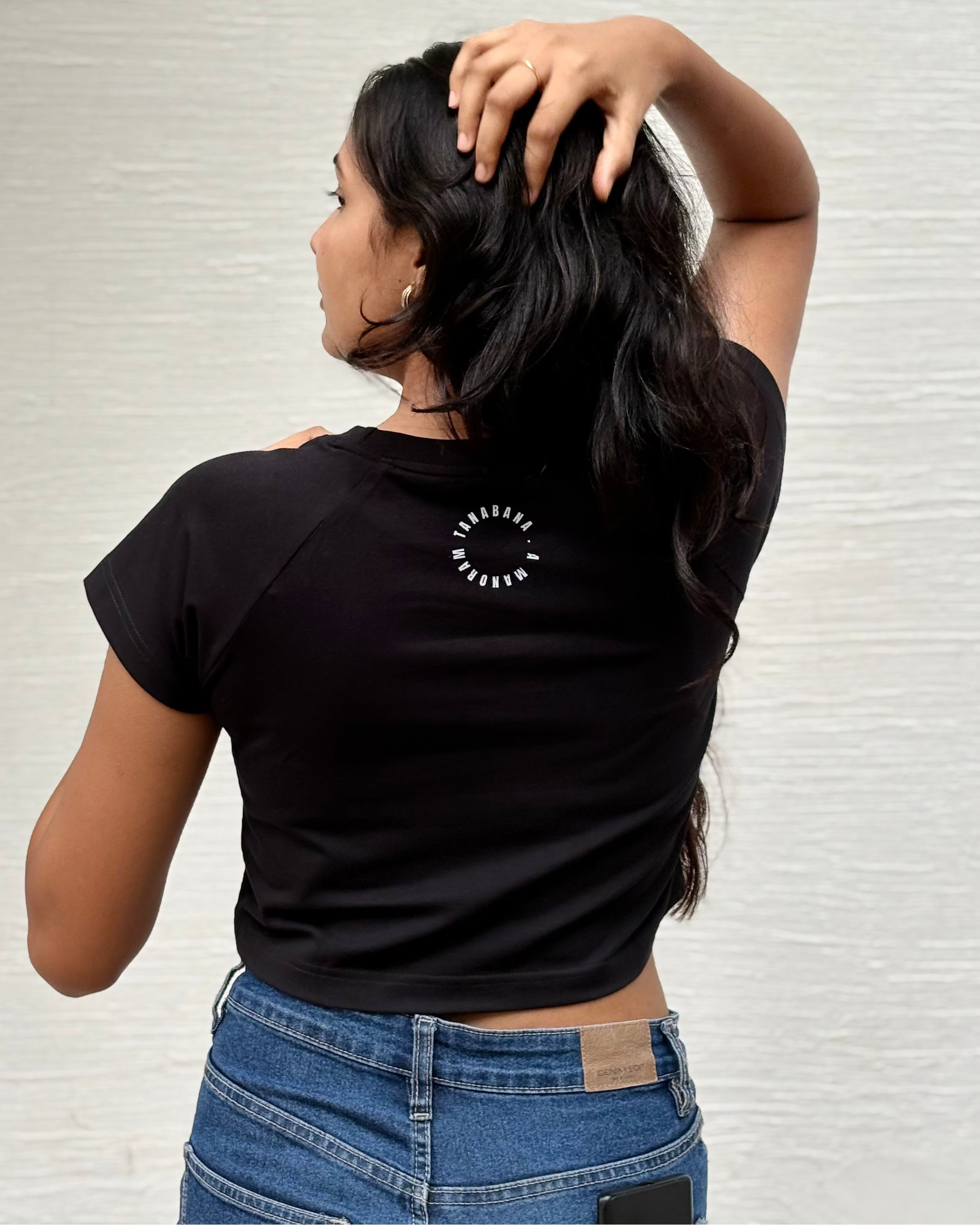 Sketched girl with roses in her hair and falling coral petals, back view black t-shirt worn by model - Tanabana A Manoram