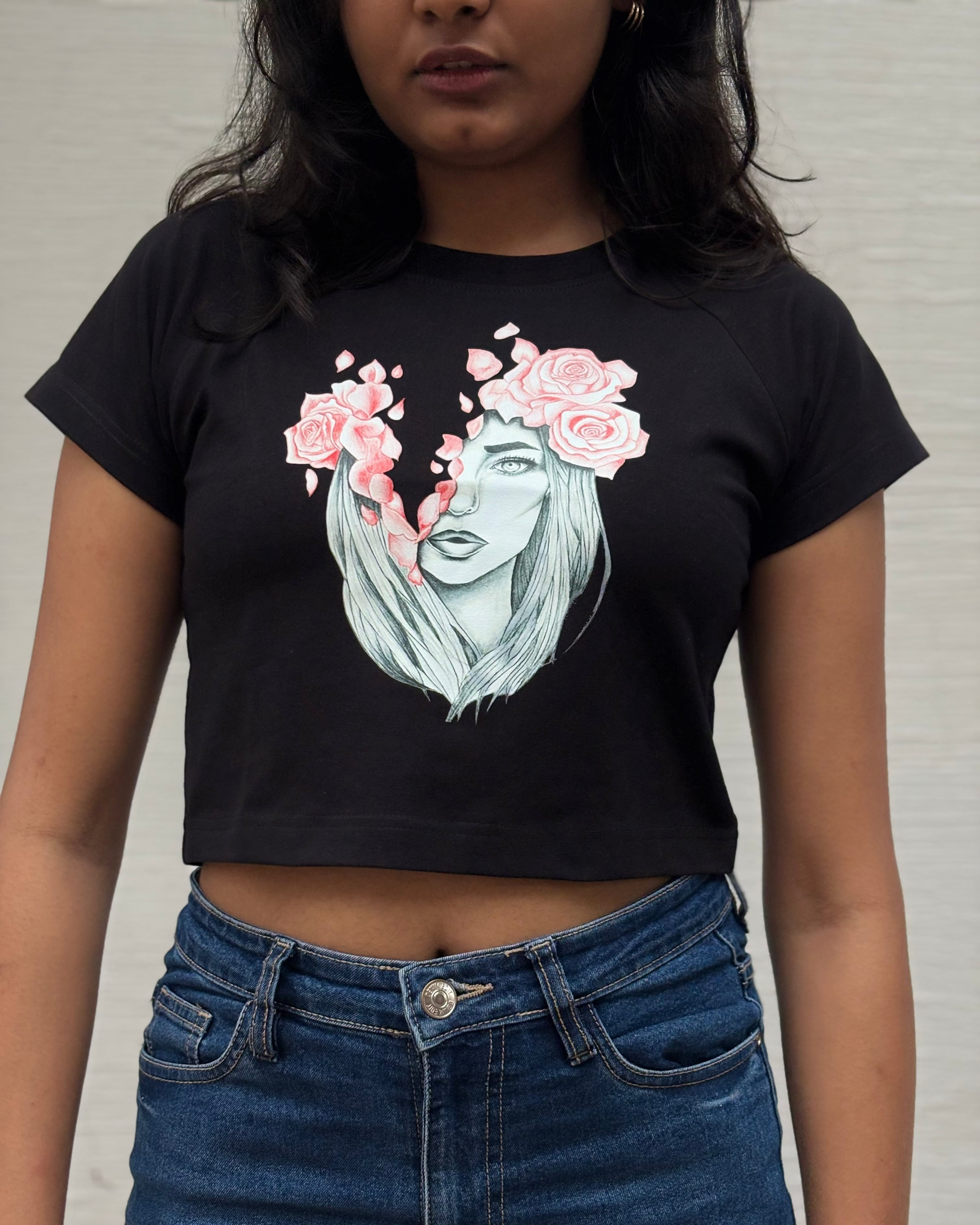 Sketched girl with roses in her hair and falling coral petals, front close up  view black t-shirt worn by model - Tanabana A Manoram