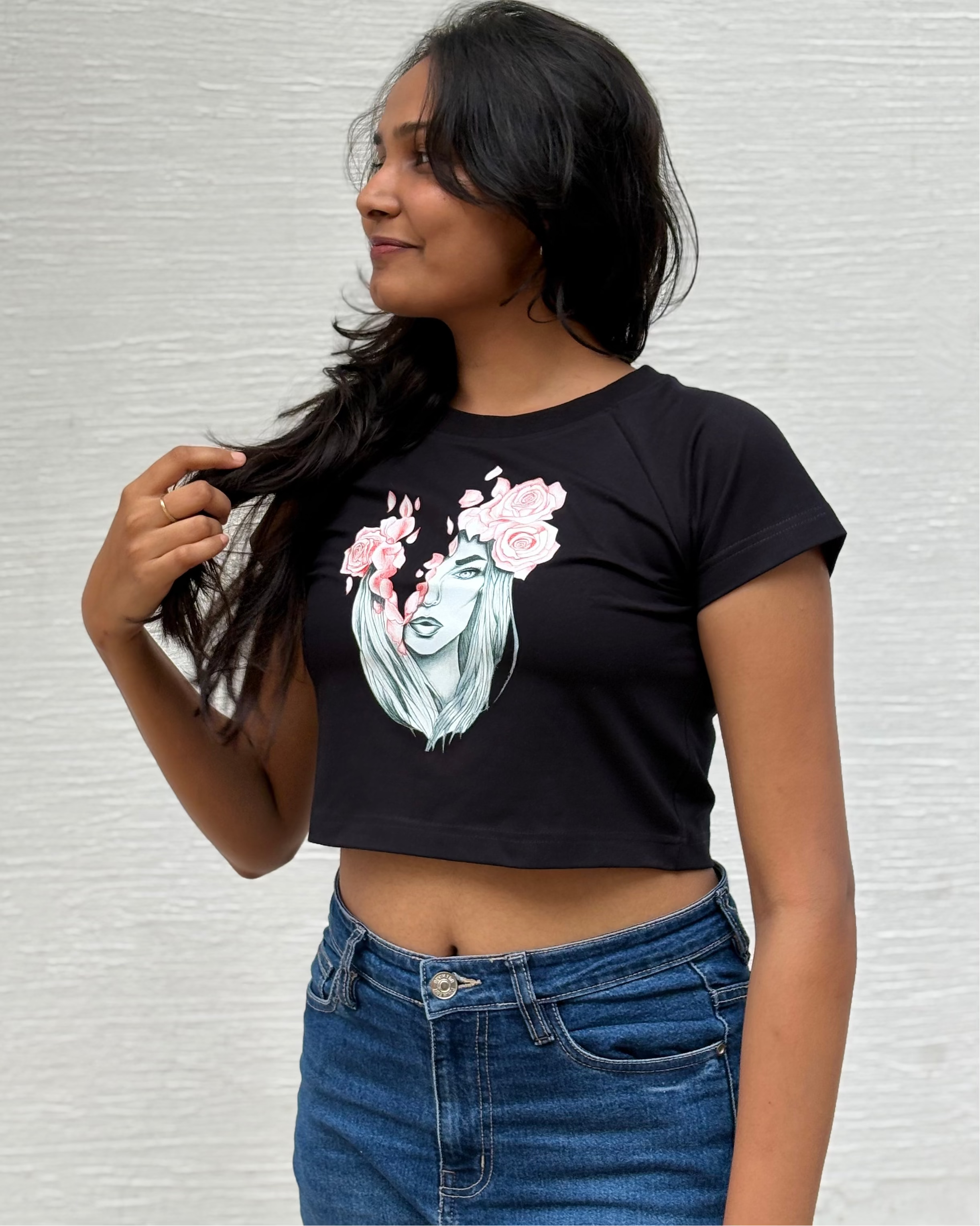 Sketched girl with roses in her hair and falling coral petals, front view  black t-shirt worn by model - Tanabana A Manoram