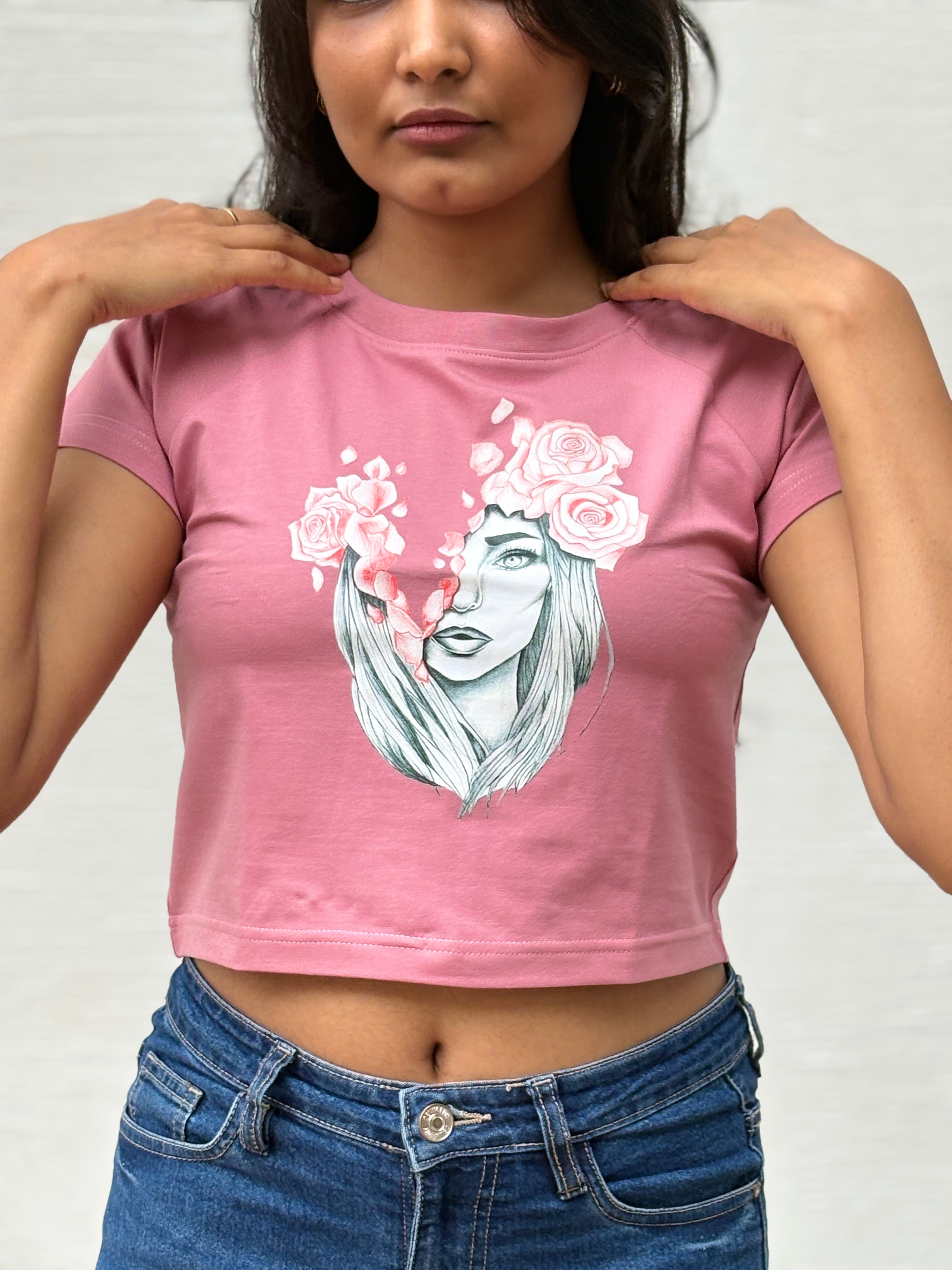 Sketched girl with roses in her hair and falling coral petals, front view  pink t-shirt worn by model - Tanabana A Manoram