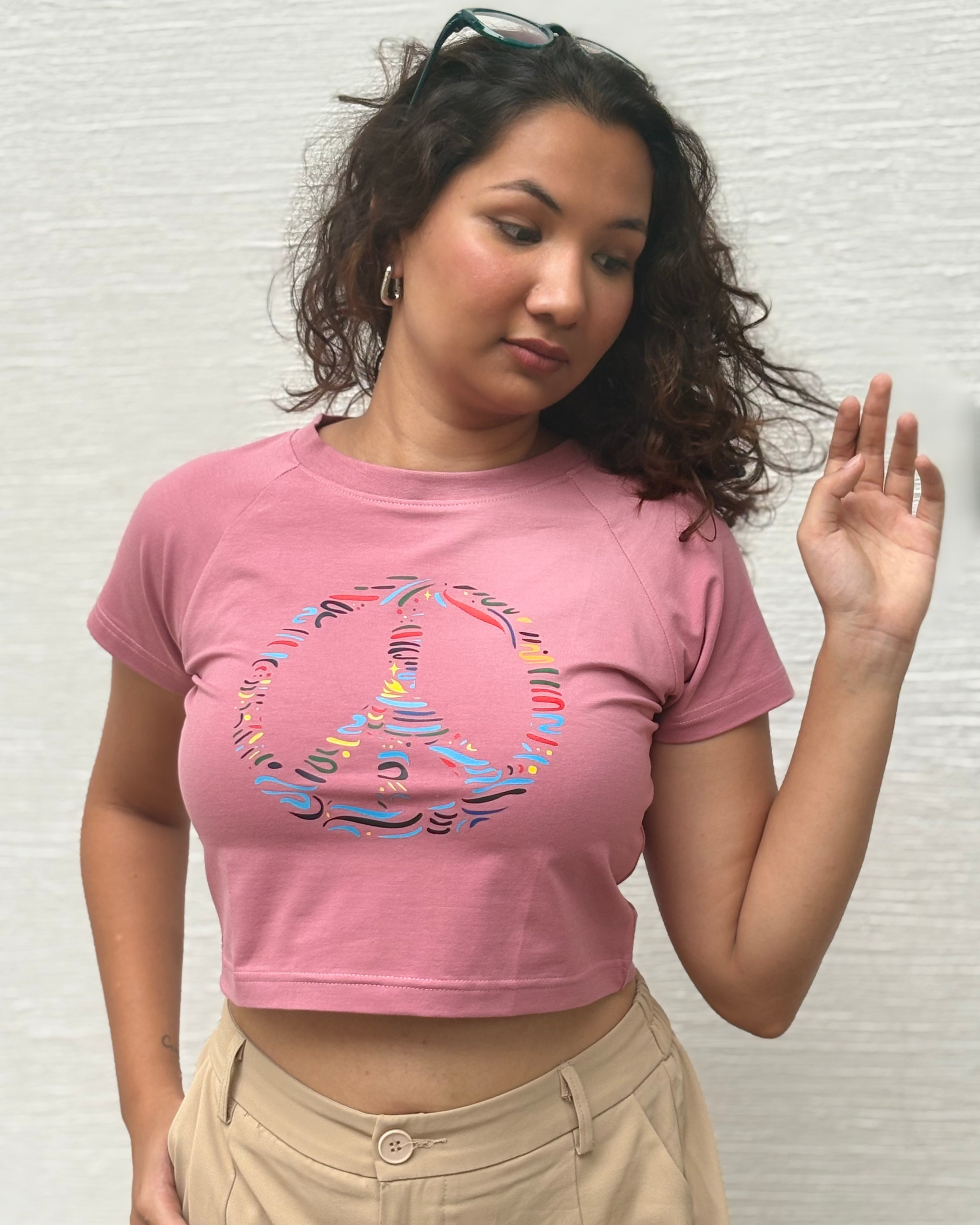 Colourful brush-stroke peace symbol artwork, front view onion t-shirt worn by model - Tanabana A Manoram