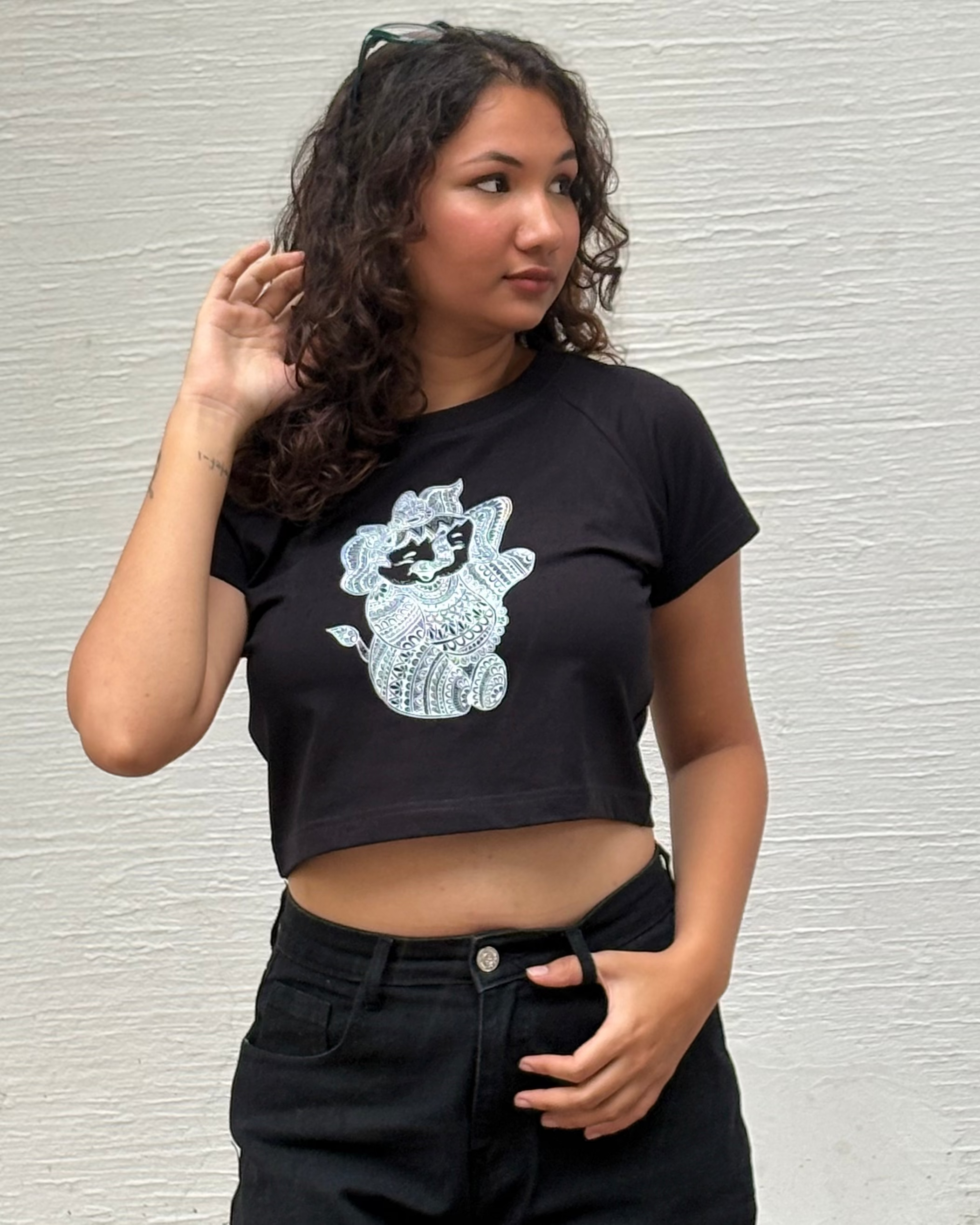 Hand-drawn mandala Baby Ganesha illustration print, front view black t-shirt worn by model - Tanabana A Manoram